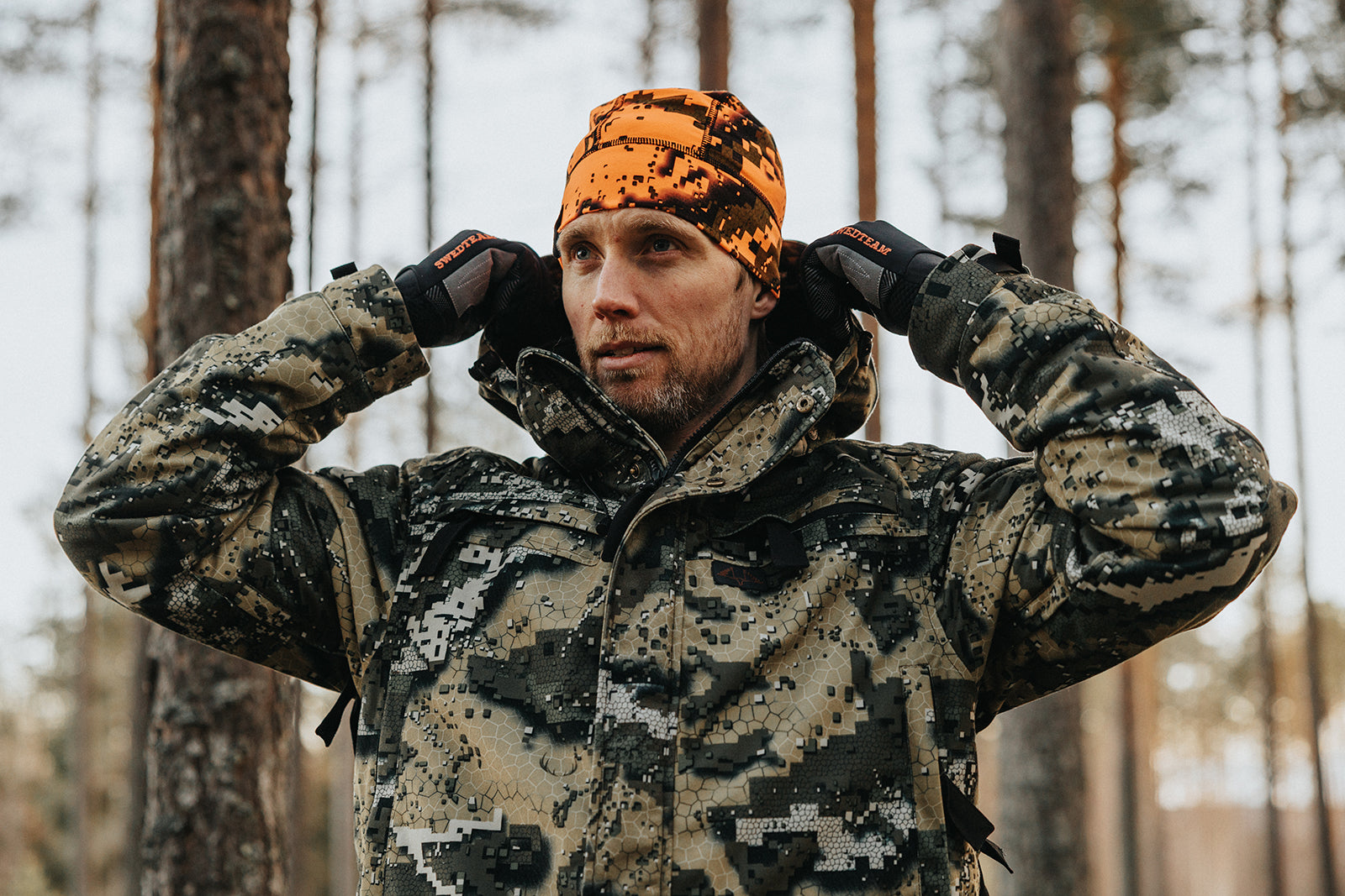 Ridge Thermo Jacket in camouflage worn by hunters in a forest environment